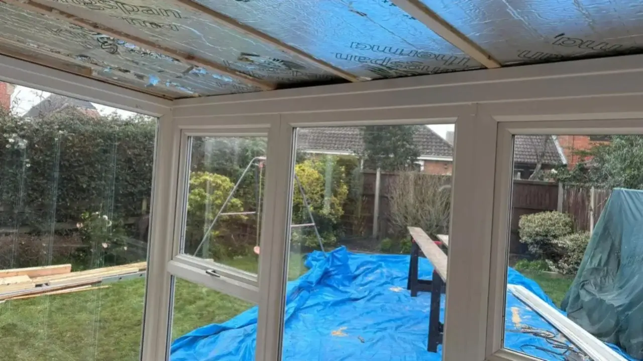 Bright, spacious interior of a completed modern conservatory showing clean tiled flooring and a high vaulted ceiling. By Norfolk Exterior Solutions